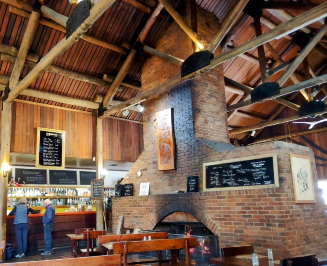 Inside the Derwent Bridge hotel. Cavernous ceilings and no insulation are mitigated by the log fire.