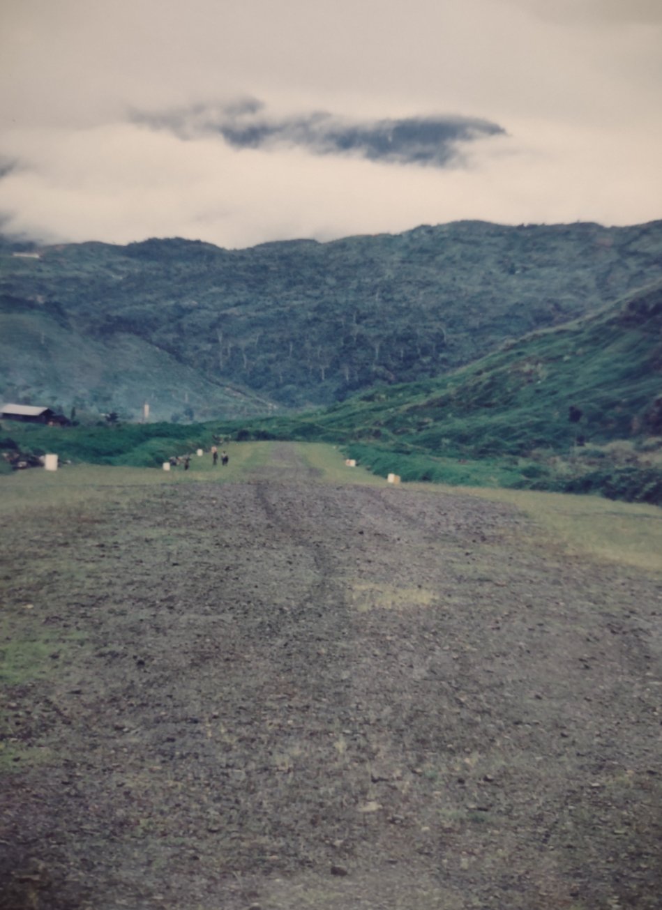 Lumpy airstrip - additional research indicates this is Silimo. Near the airstrip, an American missionary couple had lived in an American style log cabin since the 1960s. The family recently completed the 50 year task of translating the Bible into the local Ngalik language.