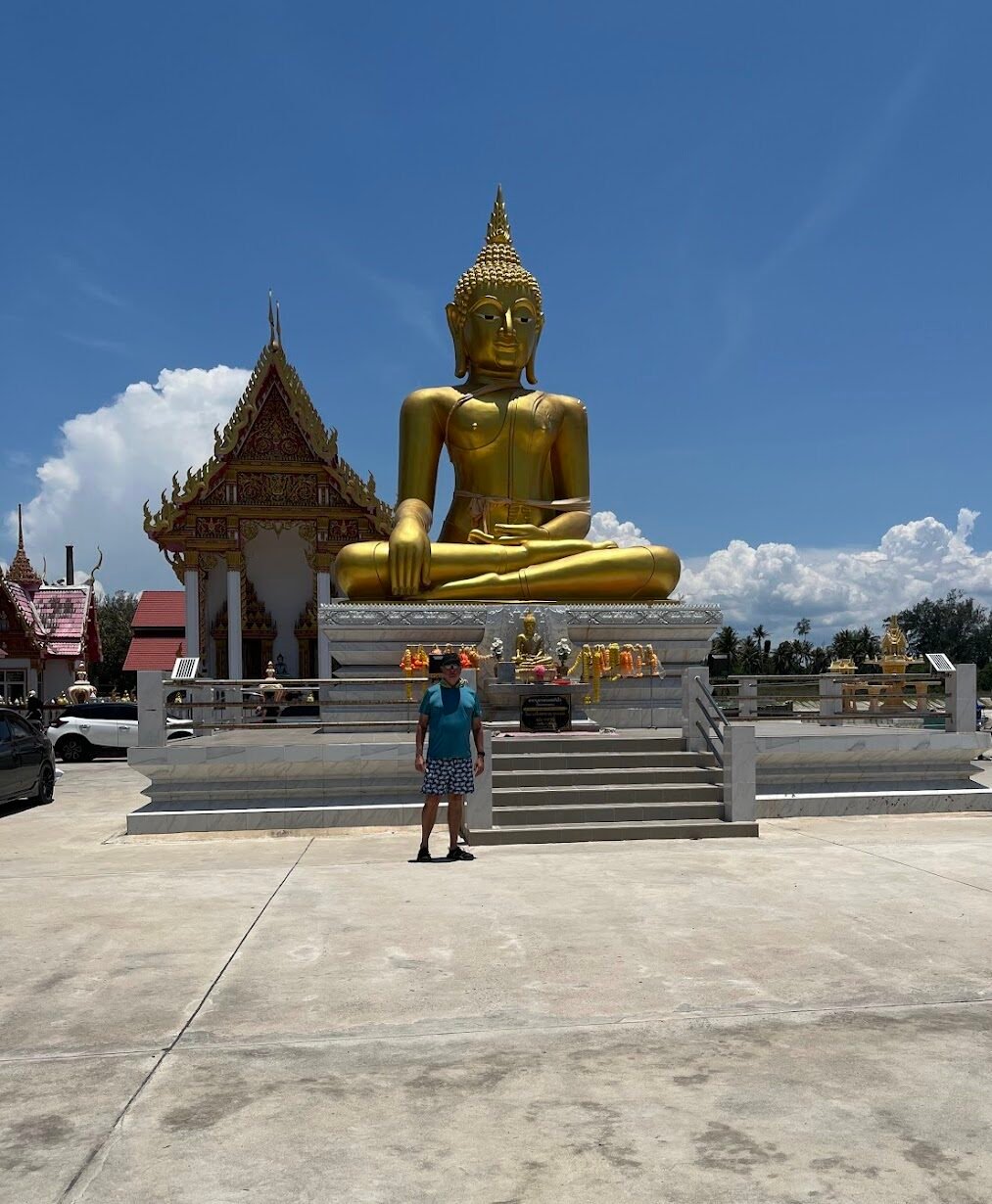 Buddha by the bay at Bo Thong Lang near Bang Saphan, Thailand. His gaze captures families swimming in the ocean, as well as local squid fishermen. And if he cranes his neck, he might see the industrial port not far away.