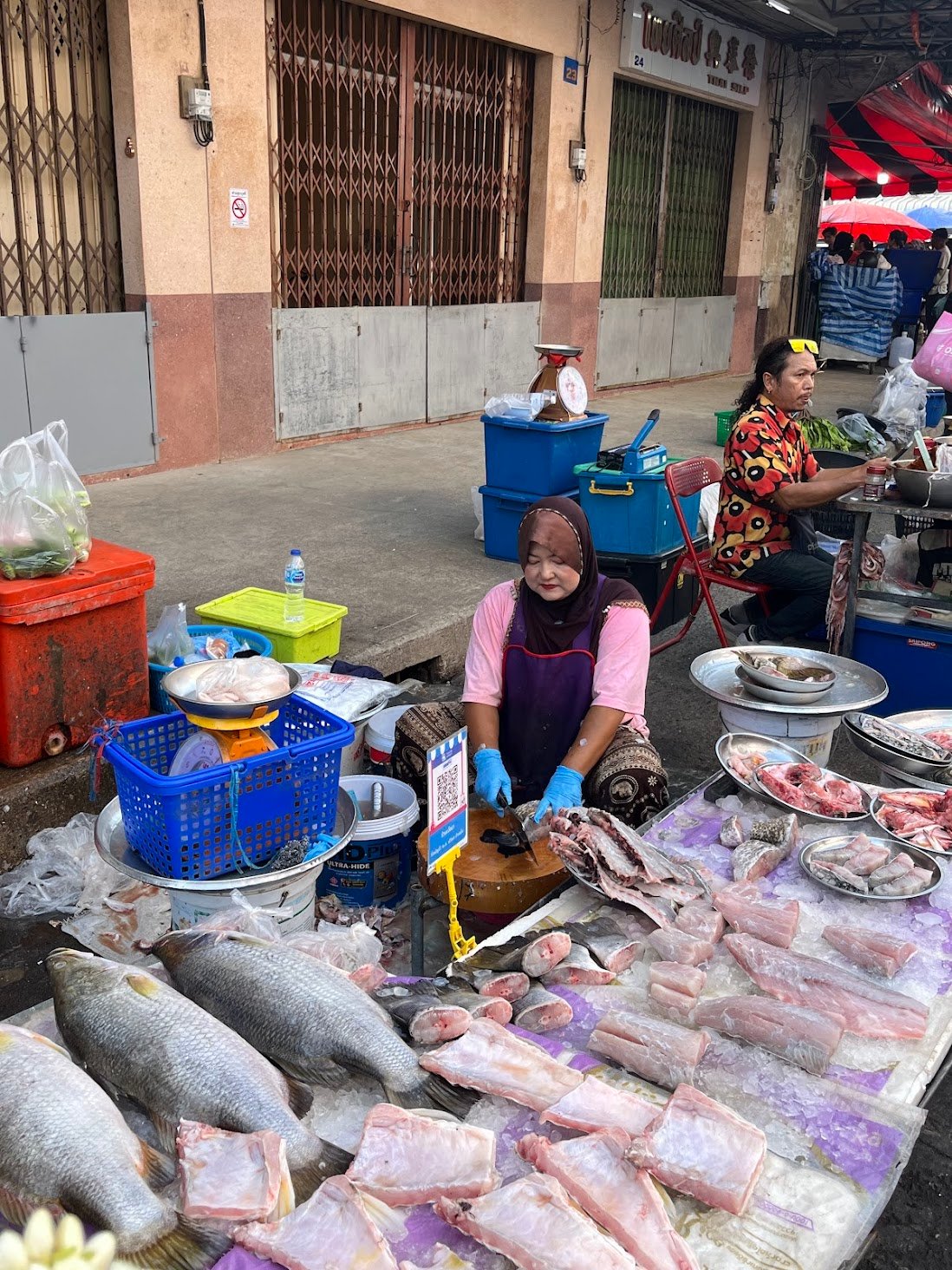 Fish seller at Hat Yai market, May 2026.