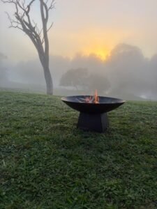 Campfire at the Man from Snowy River Festival in Corryong, Victoria, Australia. A cold morning but the sun will soon burn the mist away.