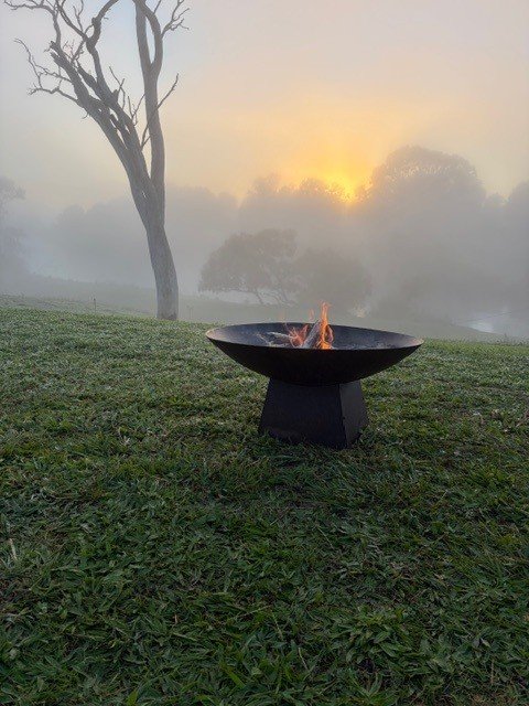 Campfire at the Man from Snowy River Festival in Corryong, Victoria, Australia. A cold morning but the sun will soon burn the mist away.